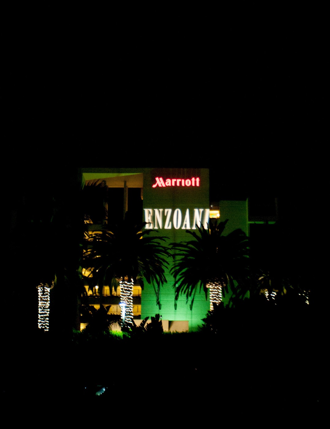 Enzoani name lit across the Newport Beach Marriott at night