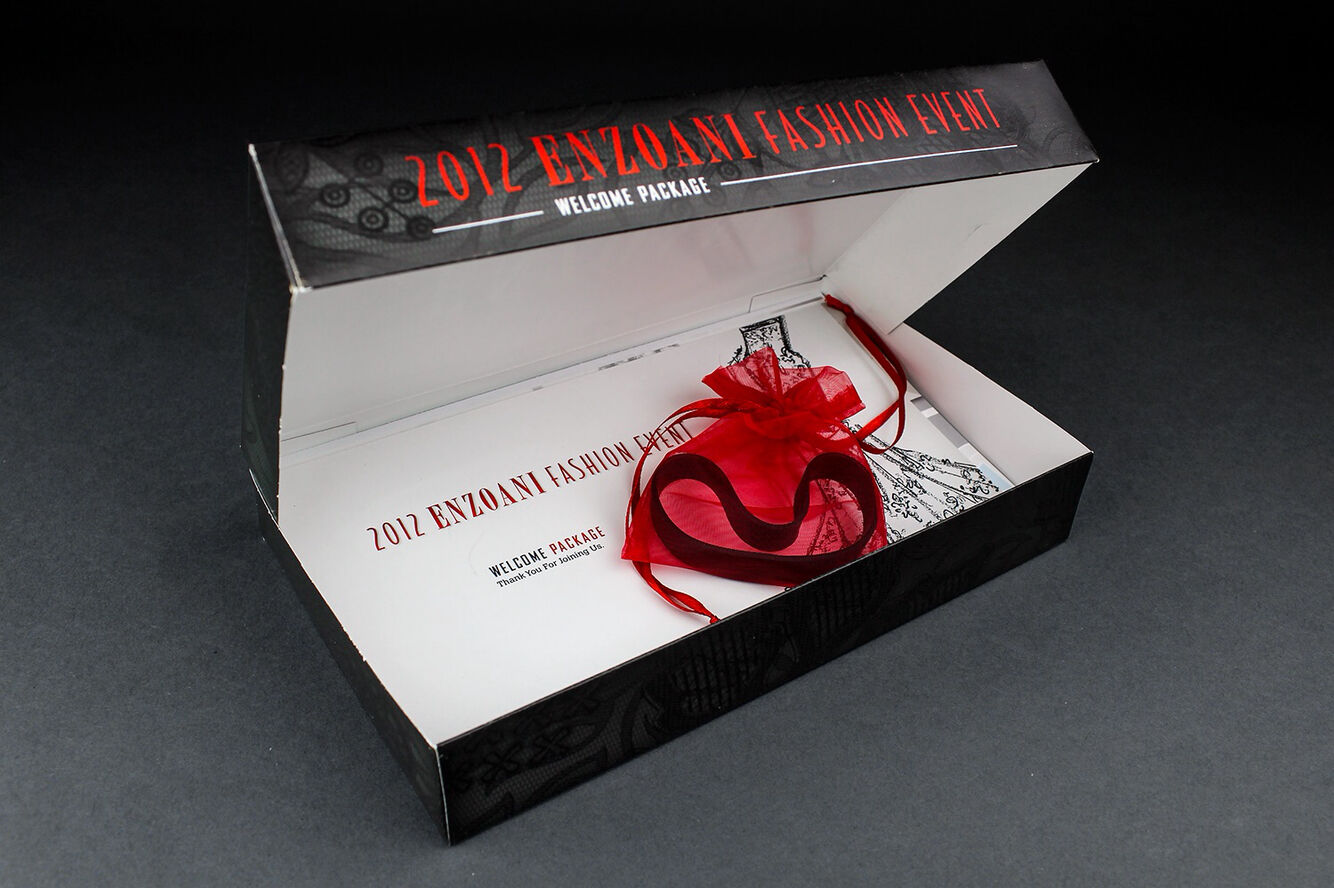 Opened 2012 Enzoani welcome package with red organza pouch