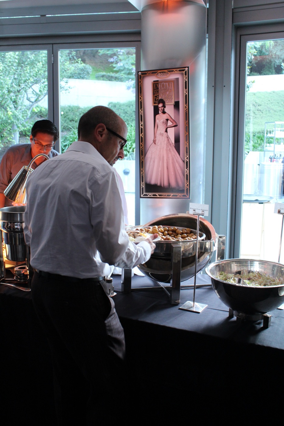 Chef serving at the 2015 dinner buffet with an anniversary gown banner in the background